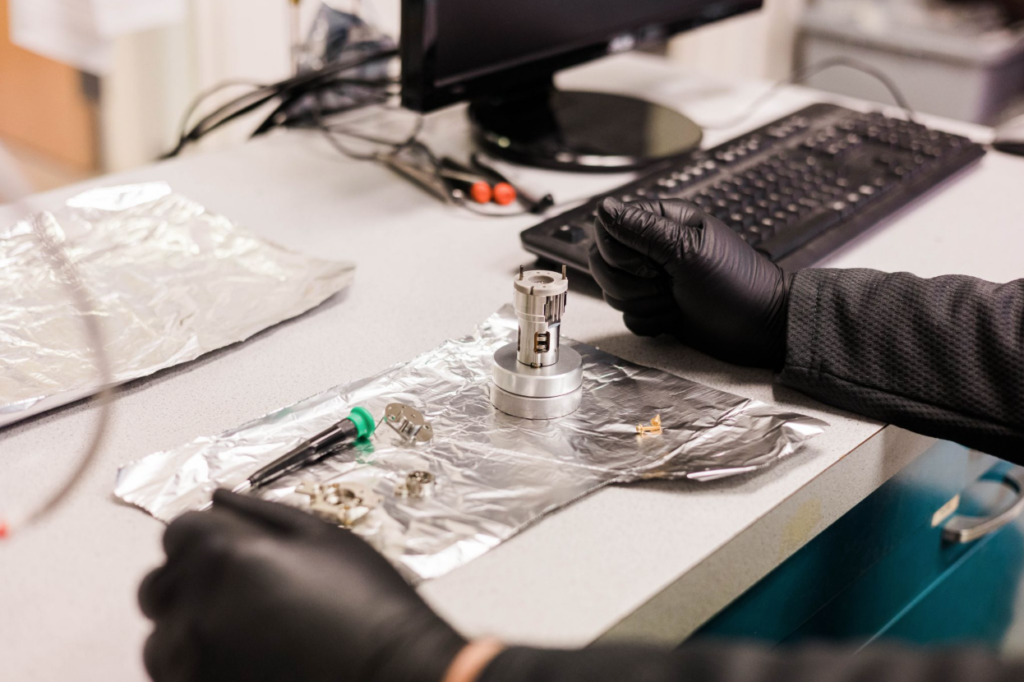 Staff conducting laboratory tests on new complex analytical equipment.